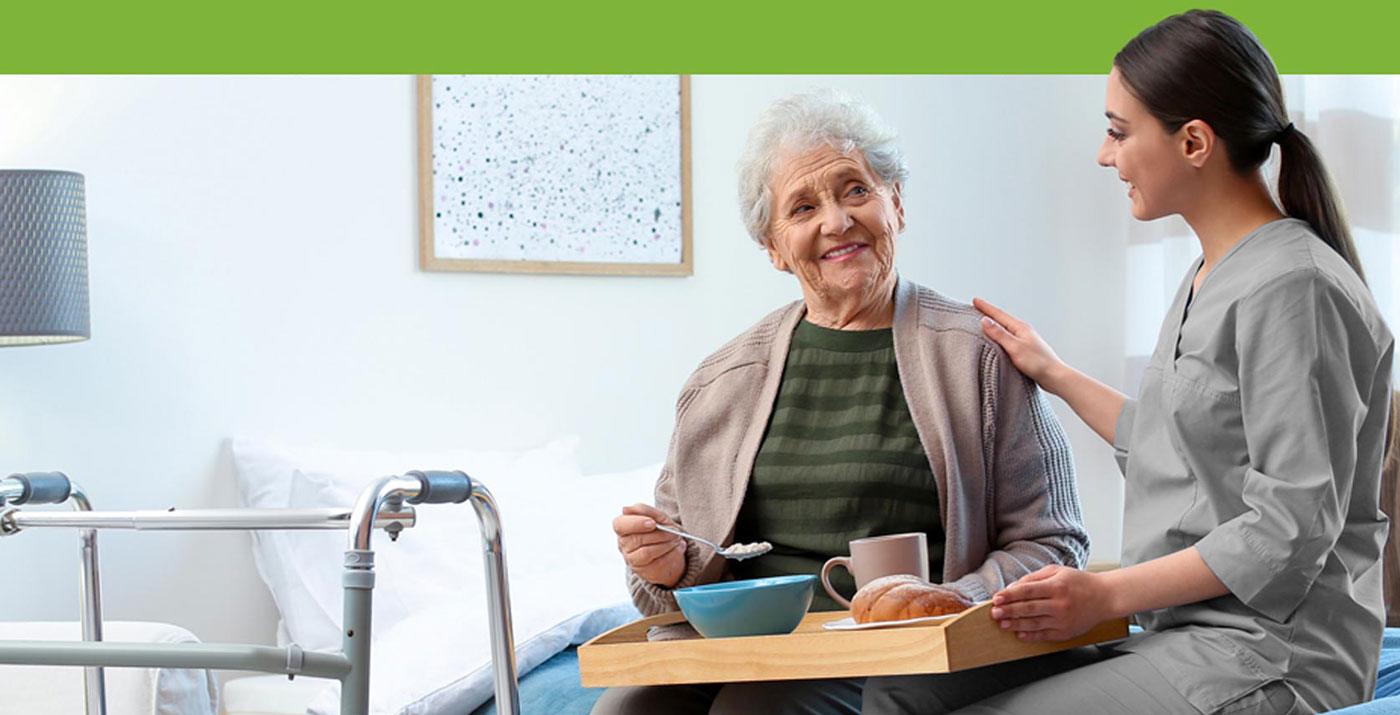 KD Care Services carer sitting and talking with an elderly lady