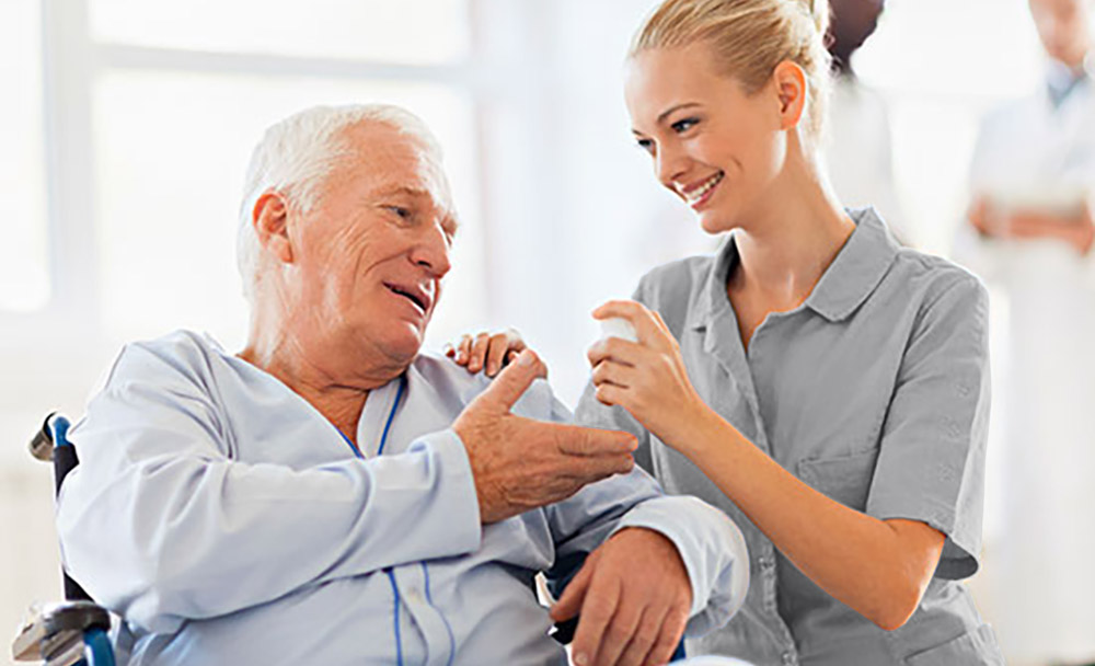 care nurse addisting an elderly patient